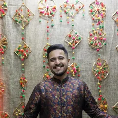 A smile against a backdrop of traditional Indian decor. I love everything about our culture, from the music and festivals to the beautiful handmade crafts that adorn our celebrations.