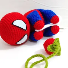 Spiderman taking a little break with a crochet strawberry.