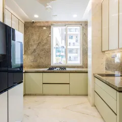 This wide view showcases the spacious layout and the beautiful marble flooring. The large window allows for plenty of natural light, making the kitchen a bright and pleasant space to work in.