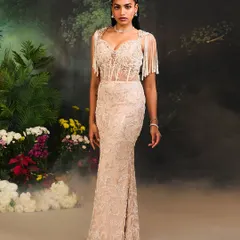 The Nuray Gown, a masterpiece of craftsmanship. This fitted gown features delicate pearl work and cascading tassels on the shoulders, designed to captivate and mesmerize.