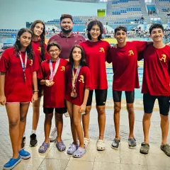 A group of my swimmers after the Delhi Open Swim Meet. The camaraderie and shared sense of achievement are just as important as the medals.
