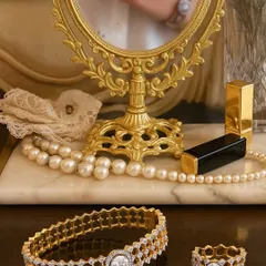 True luxury is jewellery that feels like a part of you. Here, a custom honeycomb bracelet and matching ring, both set with brilliant diamonds, rest on a vanity. I design each piece to integrate seamlessly into your life, adding a touch of personal elegance to your daily moments.