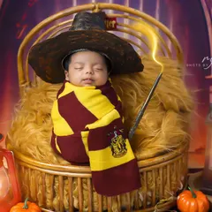 Our littlest wizard. This Harry Potter themed newborn shoot is pure magic, complete with a sorting hat, wand, and Gryffindor scarf.