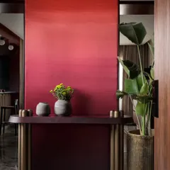 We believe in making bold statements. The foyer of our Scarlet Horizon project features a dramatic, hand-painted ombré wall that transitions from deep crimson to a vibrant scarlet. This entryway console and greenery create a powerful first impression that is both artistic and welcoming.