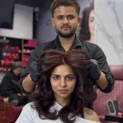 This client is feeling her new reddish-chocolate brown hair. The color is vibrant, and she looks fantastic.