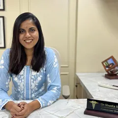 A photo of me at my desk. As a consultant dermatologist, I am dedicated to providing solutions for all your skin and hair concerns, ensuring you feel heard and understood.