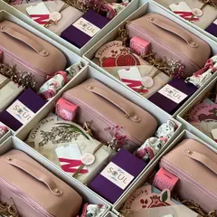 An overhead view of the Women's Day hampers, all neatly packed and ready to be gifted. The consistent pink and purple color scheme creates a beautiful, cohesive look.