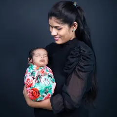 A new mother gazes lovingly at her sleeping newborn, holding her close. This simple, classic portrait captures the profound bond and tenderness of early motherhood.