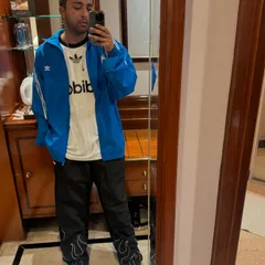 A quick mirror selfie showing off my fit before a gig. Rocking a classic Adidas look.