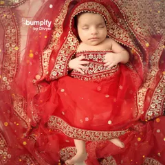 Wrapped in a stunning miniature red and gold lehenga, this newborn looks like a tiny sleeping princess. I love creating these traditional looks that connect your baby's first portraits to your family's heritage.