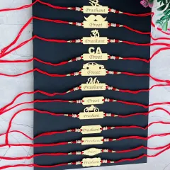 A collection of my custom name rakhis with various symbols like Om, a car, a mustache, and a motorcycle, allowing you to match the rakhi to your brother's personality.