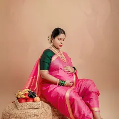 A quiet moment of reflection for the mother-to-be. The elephant motif in the background is a symbol of strength and good fortune, adding a deeper meaning to this traditional maternity portrait.