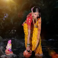 A themed shot for Ganesh Chaturthi, with the model performing a ritual by a stream, creating a spiritual and beautiful scene.