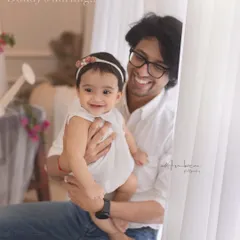 "Daddy's darling." The pure joy shared between a father and his baby girl. His infectious smile and her happy expression make this a truly heartwarming portrait.