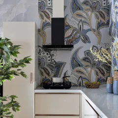 A bold and beautiful kitchen featuring a stunning blue and grey floral mosaic backsplash. The neutral cabinets provide the perfect balance, allowing the intricate tilework to be the star of the show.