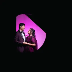 A unique, framed composition using negative space. This artistic shot creates a feeling of looking in on a private, happy moment between the couple.