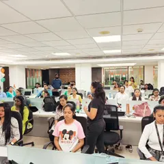 Leading a guided meditation session for a corporate team. These simple mindfulness techniques can be done right at the desk to reduce stress and improve concentration.
