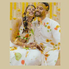 A joyful, turmeric-covered kiss between Avin and Nikki. This close-up captures the fun and intimacy of the Haldi ceremony perfectly.