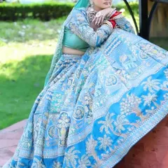 For a day wedding or a vibrant mehndi, I can design something like this stunning sky-blue lehenga with detailed embroidery that looks incredible in natural light.