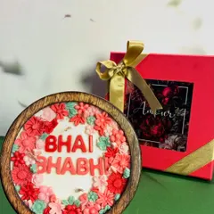 A beautiful shot of my custom "Bhai Bhabhi" floral candle next to its elegant red gift box. This handcrafted candle in a wooden bowl is a unique and heartfelt gift for Raksha Bandhan.