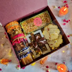 This hamper is packed with variety. It includes jars of my homemade treats with decorative fabric tops, a box of brownies, flower-shaped white chocolates, and a delicious tea cake, all presented in a gorgeous gift box.