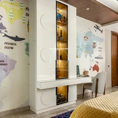 We also designed this smart study and storage unit for the same room. The integrated desk, display shelves, and closed cabinets provide ample space for learning and organizing, all tied together with a fun world map wallpaper.