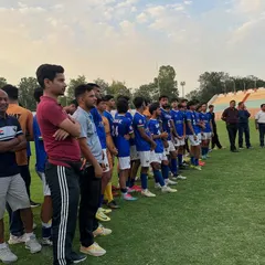 The calm before the storm. The team lined up, waiting for the trophy presentation after a hard-fought season. This is a moment of pride for the entire club.