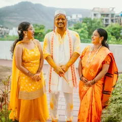 A happy, candid family portrait of the groom sharing a laugh with his family during the Haldi ceremony.