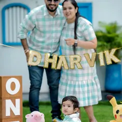 A cheerful first birthday celebration outdoors. This family's matching outfits and the festive "ONE" blocks create a picture perfect memory of this important family milestone.