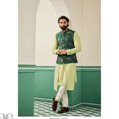 A full-length view of the emerald green bundi set, showing how the asymmetrical kurta and tailored jacket create a dynamic and elegant silhouette.