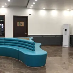 Another view of the school reception waiting area. The space is designed with durable marble-finish flooring, subtle wall paneling, and ample overhead lighting to create a bright and clean environment.