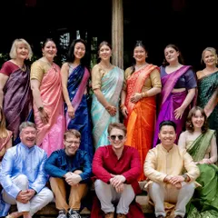 Guests from around the world dressed in vibrant sarees and kurtas, celebrating a beautiful fusion wedding at our venue.