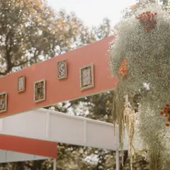 A detail of the canopy, adorned with personal framed photos, adding a unique and sentimental touch to the wedding decor.