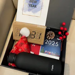 A close-up of the New Year hamper for Cipla, showing the 2025 desk calendar, LED clock, and other festive touches.