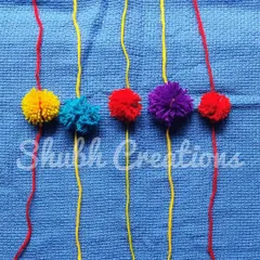 A set of simple yet colorful rakhis made from fluffy yarn pompoms, perfect for a soft and reusable option.