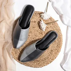 A rustic and chic flatlay for a pair of metallic mules. The use of a jute mat and soft, natural fabrics creates an earthy and stylish vibe, perfect for a brand with a bohemian aesthetic.