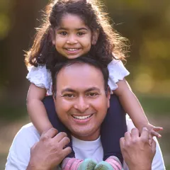 The special bond between a father and his daughter. This close-up shot, filled with sunshine and smiles, is a perfect keepsake from a family photoshoot.