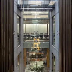 We design interiors as dynamic volumes. At the Laxcon office, we orchestrated a series of triple-height spaces, open-to-sky courtyards, and connecting bridges to foster a sense of openness and visual connection for the workforce, while also responding to the arid climate.