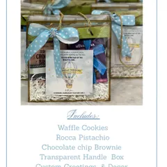 This image shows the contents of our transparent handle box return favor. It includes waffle cookies, pistachio roca, and a chocolate chip brownie, with custom decor to match the birthday theme.