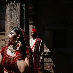 A portrait that plays with light and shadow within the stunning architecture of a heritage site. The bride is illuminated while the groom remains in the shadows, creating a sense of depth and mystery in this cinematic couple shot.