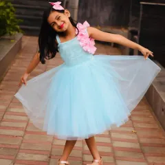 A happy client twirling in her sky blue birthday frock. The dress is made with layers of soft net, perfect for dancing and playing.
