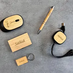This set combines eco-friendly materials with modern technology. It includes a wireless bamboo mouse, a retractable 3-in-1 USB cable, and other bamboo accessories, all personalized for "Sathish".