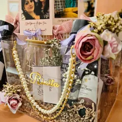 I love creating personalized gifts for the bridal party, like this custom acrylic hamper for a bridesmaid. It's filled with curated items like a jade roller, wine, and a personalized coffee tumbler to make your closest friends feel truly special.