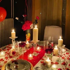 We curate romantic, luxe dinners for special occasions. This intimate table for two is set with candles, rose petals, and fine dinnerware, creating the perfect ambiance for a date night or anniversary.