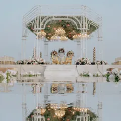 The sanctity of a vow, reflected. I designed this seaside mandap with a mirrored aisle, creating a breathtaking illusion where the structure, the sky, and the ceremony itself were perfectly duplicated, doubling the grandeur of the moment.