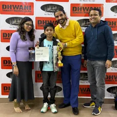 The winner with his proud parents and teacher. We believe in a collaborative approach, where teachers and parents work together to support a student's journey.