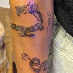 The clean, consistent lines of this serpentine dragon tattoo are a great example of my fine line work applied to a larger, more illustrative piece.