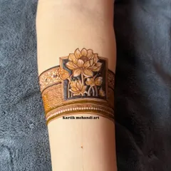A modern and chic arm band design featuring a beautifully shaded lotus flower. This minimalist style makes a sophisticated statement.