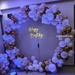 The same "Happy Birthday" circular backdrop can create a completely different feel with a change in lighting. Here, I used cool purple lighting to give the white, nude, and gold balloon arrangement a stylish and modern evening look.