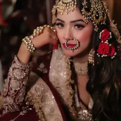 A detailed close-up of the Heeramandi-style hair and jewelry, including the intricate headpiece and fresh flowers.